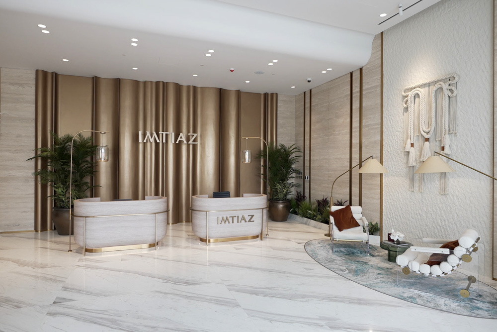 Beach Walk Residence Modern reception area featuring a sleek desk, stylish seating, decorative plants, and elegant wall design.